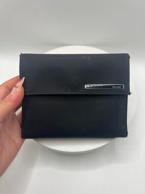 7058. Authentic Prada Black Nylon Leather Flap Wallet with Silver Logo.